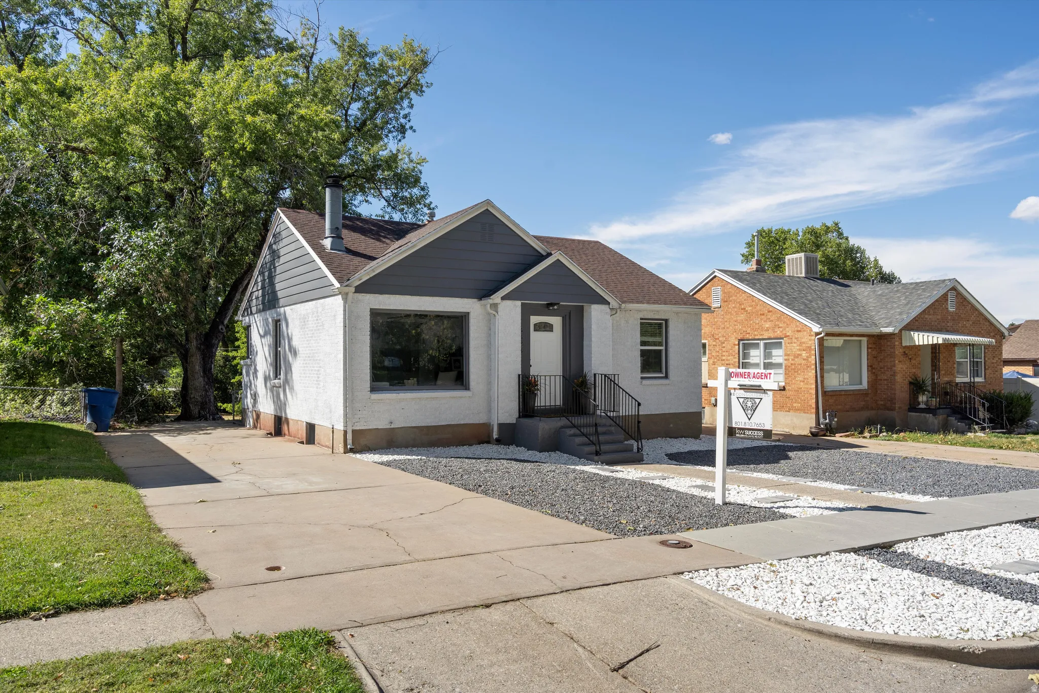 Contemporary exterior with contrasting white stucco and dark gray siding
