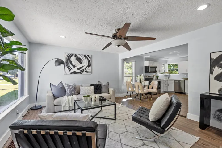 Spacious living area featuring wood-finish flooring, recessed lighting, and a ceiling fan
