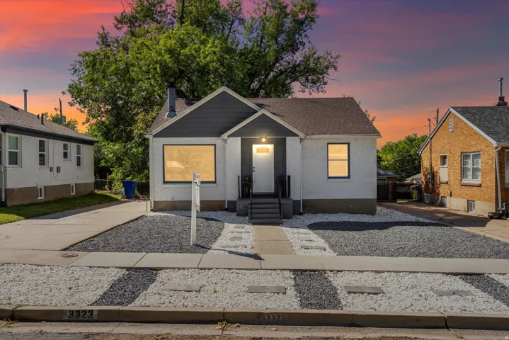Single-story residence featuring a gray and white exterior with dark trim
