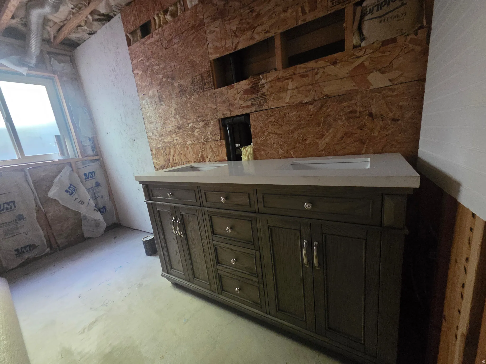 New vanity installation featuring a light-toned countertop, dual integrated sinks, and ample storage cabinetry