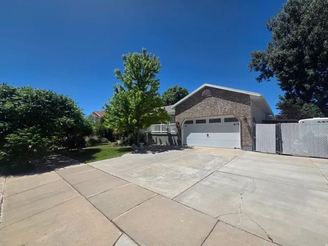 Brick-clad exterior featuring a two-car garage with a white overhead door