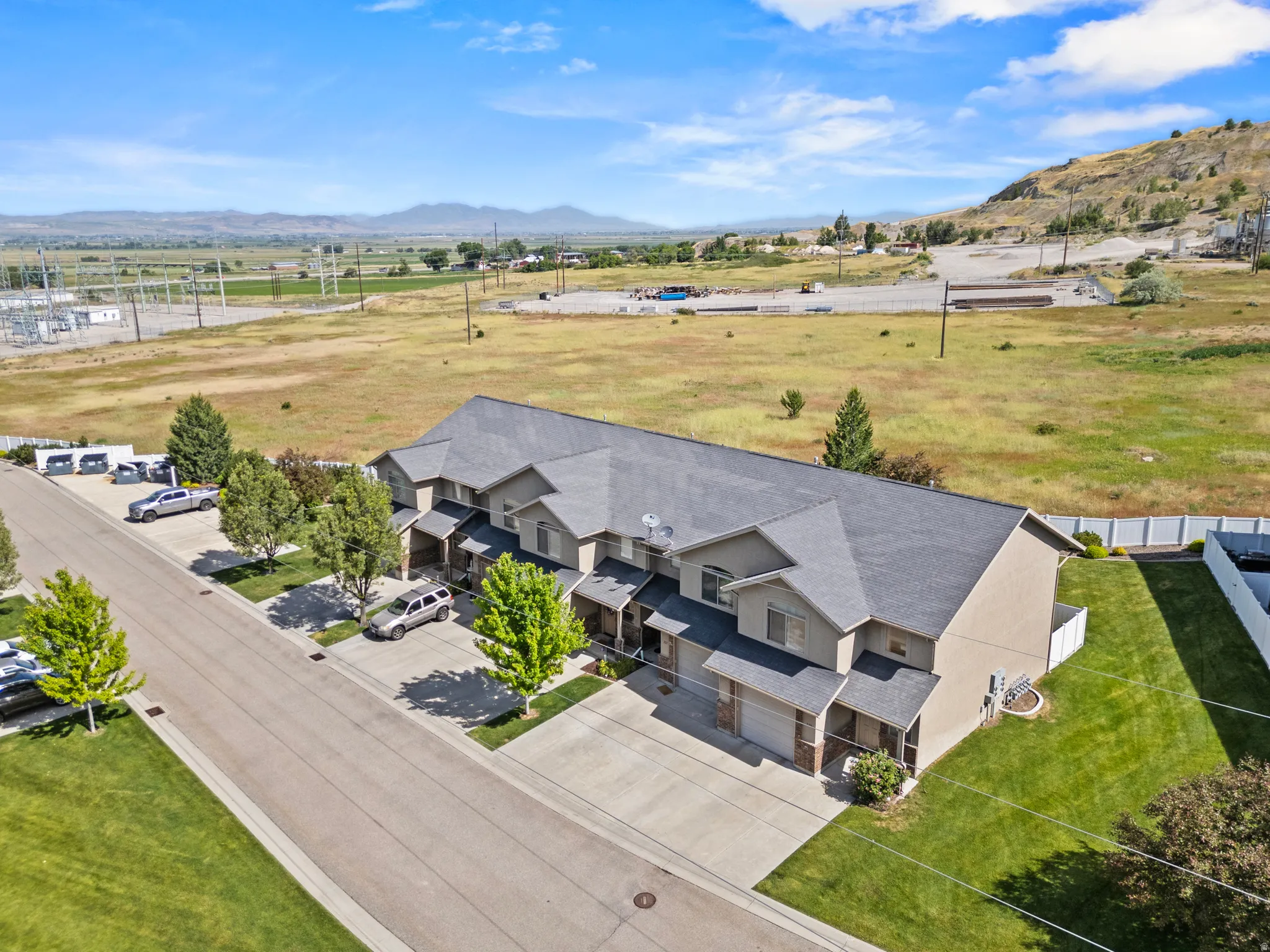 Townhome complex featuring multi-car driveways, attached garages, and individual covered entryways