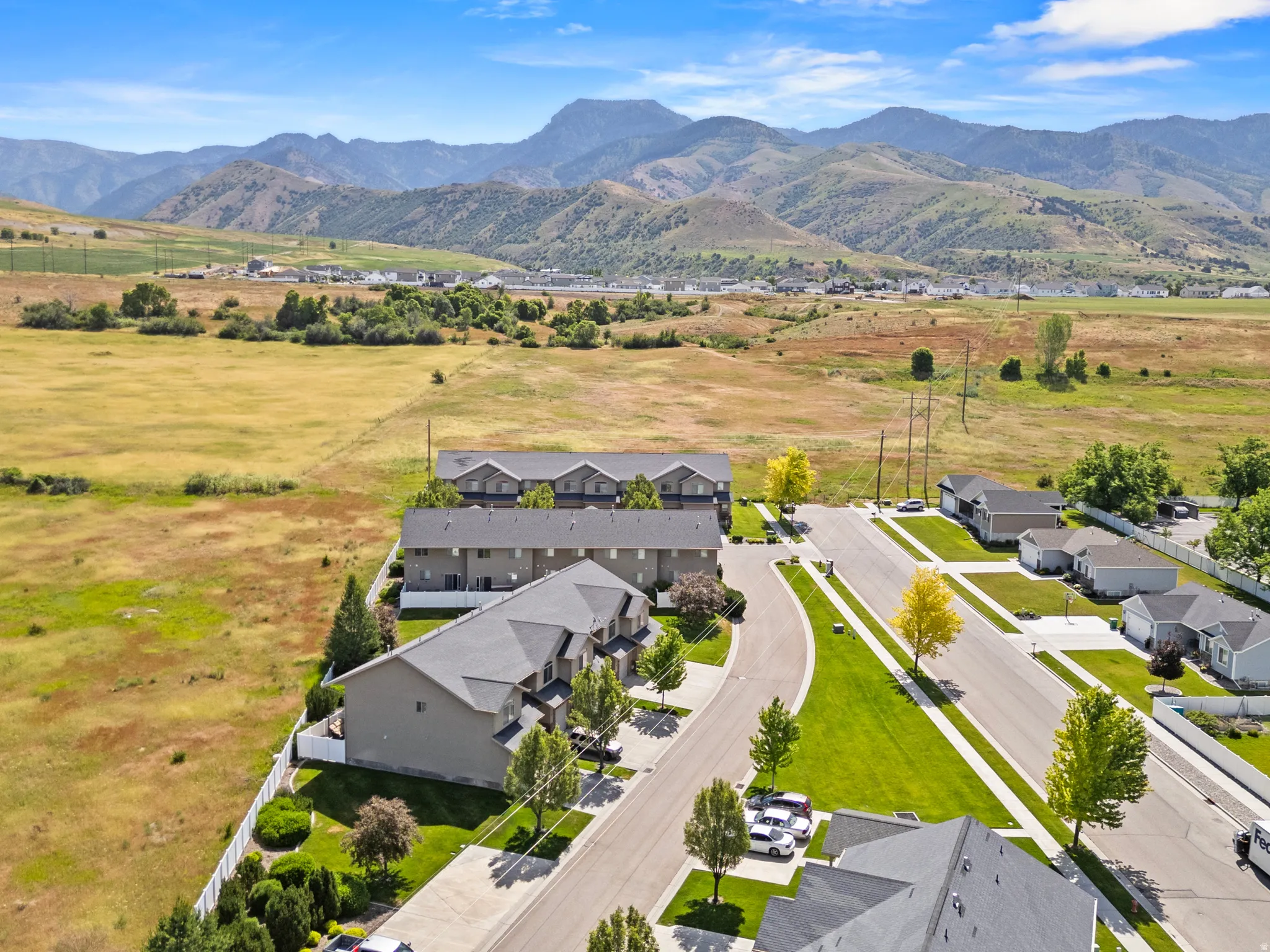 Aerial perspective showcasing a residential community with distant mountain ranges
