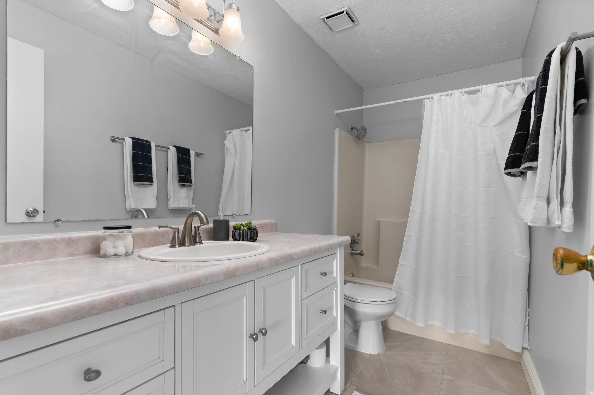 Bathroom featuring a vanity with new brushed nickel faucet and new light fixture