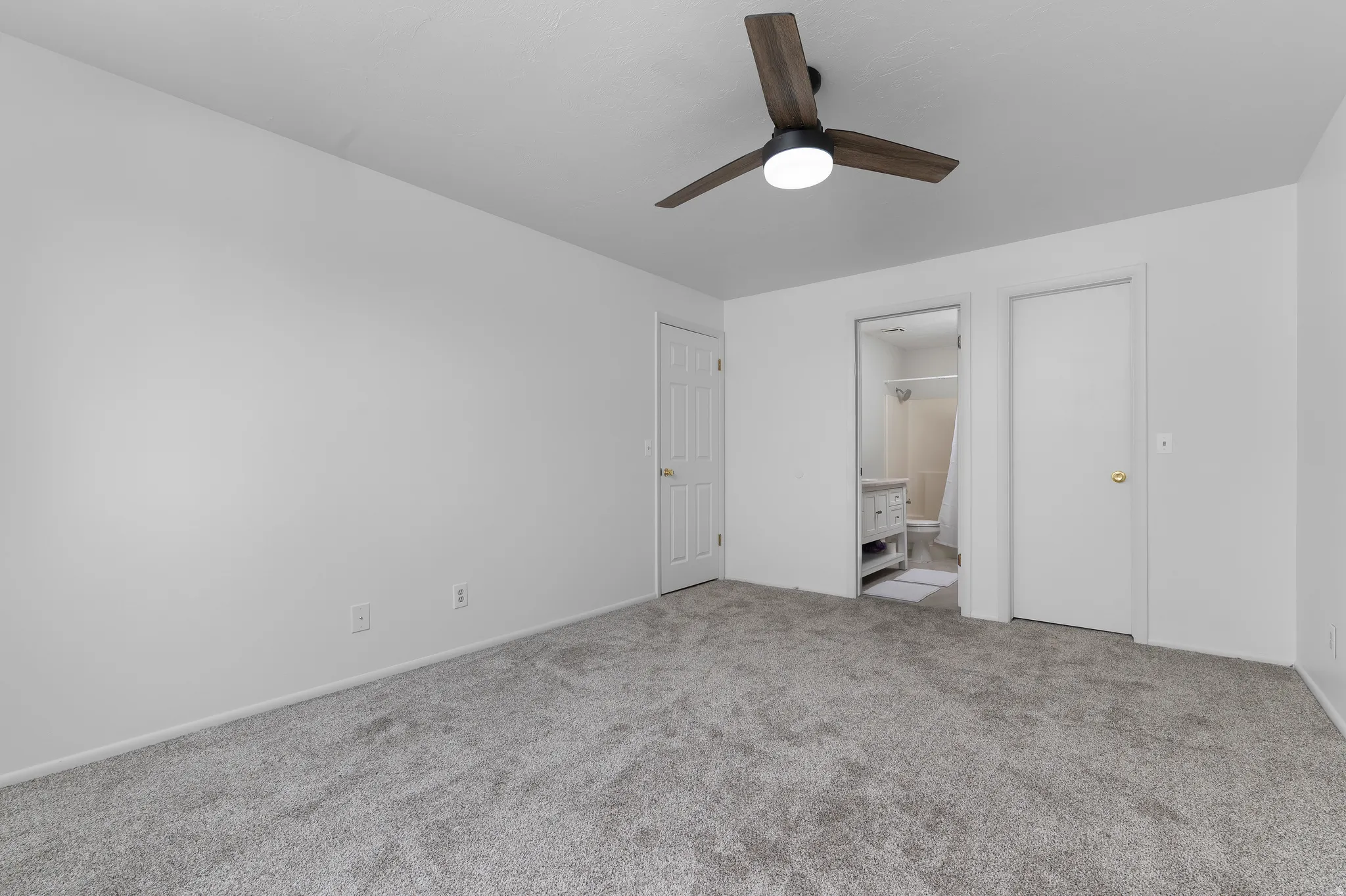 Bedroom with brand new carpeting and ceiling fan