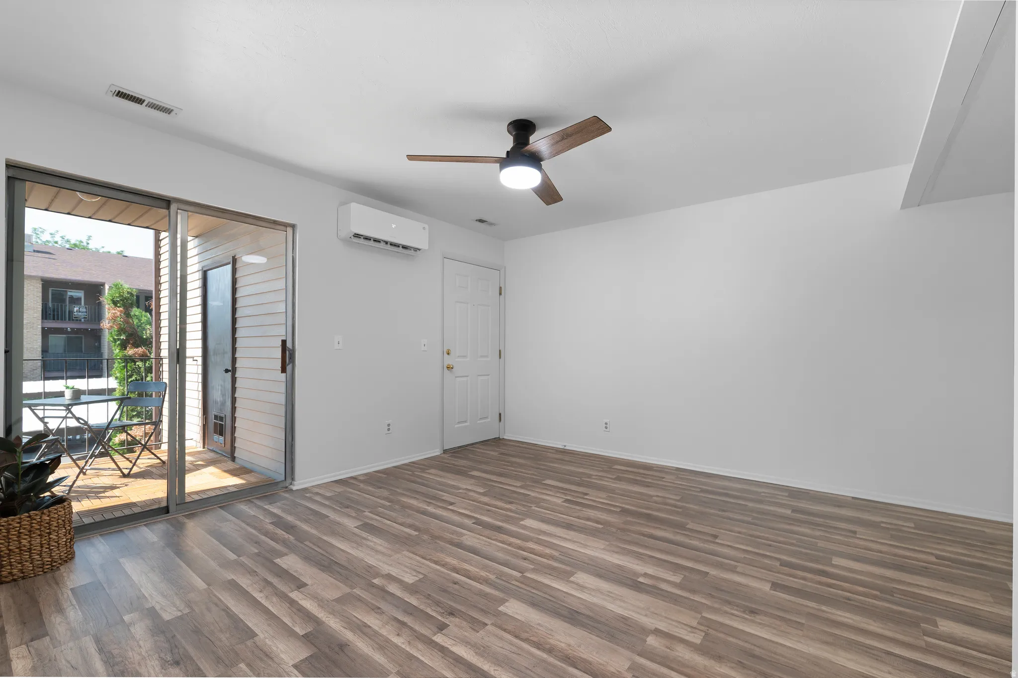Living Room with a new ceiling fan, and a mini-split air conditioning/heating unit