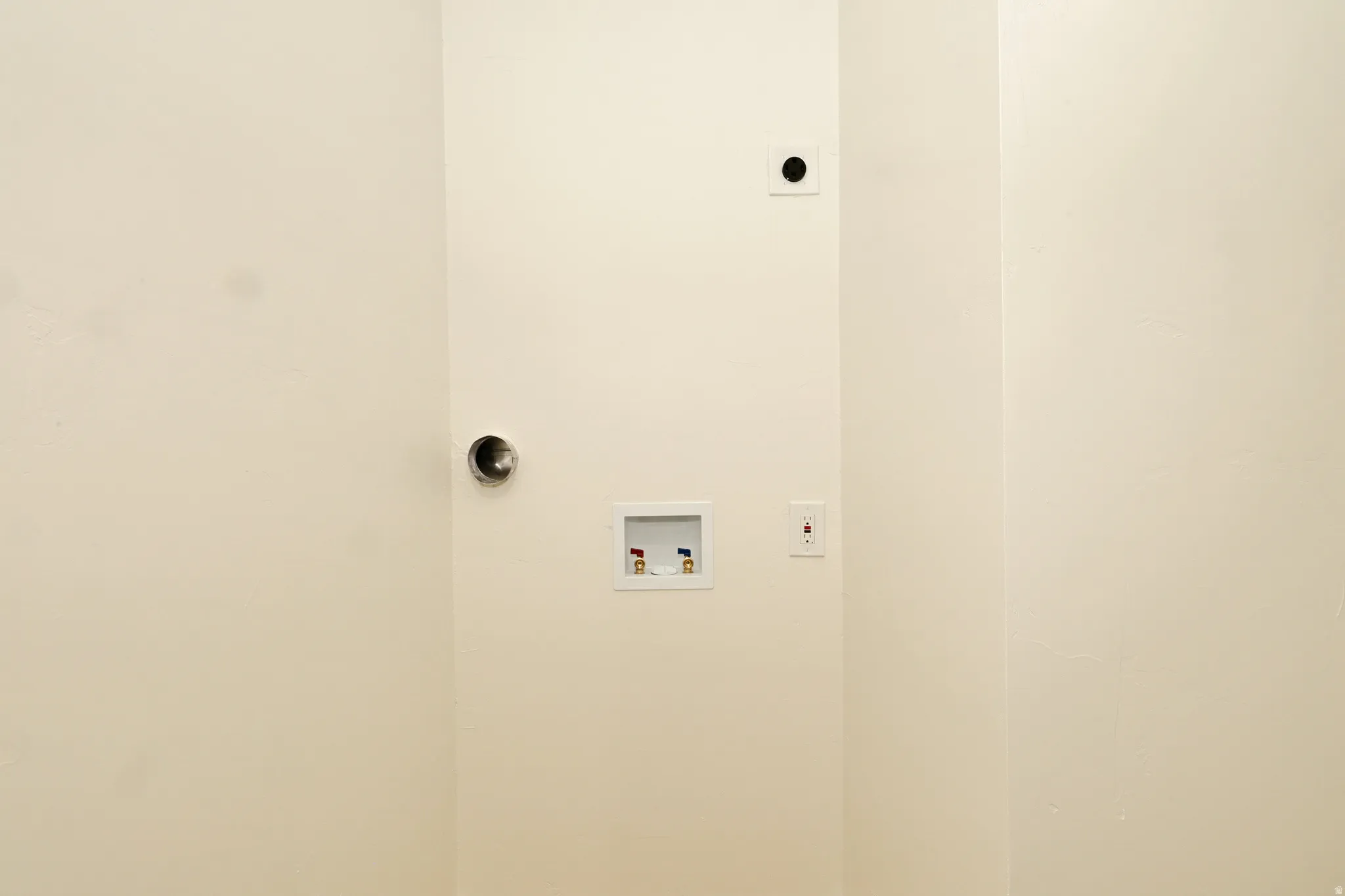 Dedicated laundry area featuring a dryer vent, washing machine hookups, and an electrical outlet