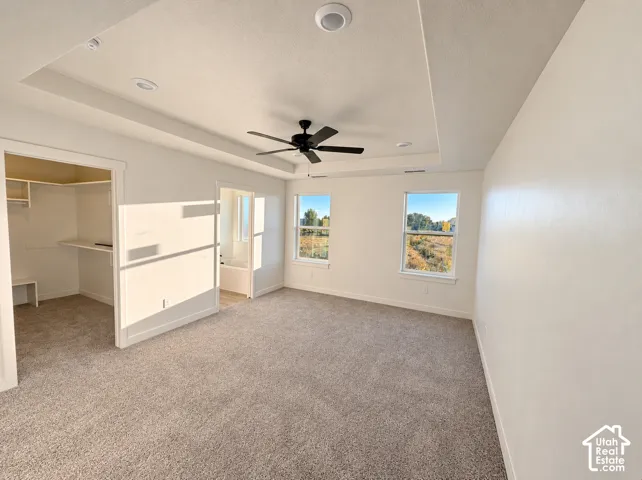 Tray ceiling with recessed lighting and a ceiling fan