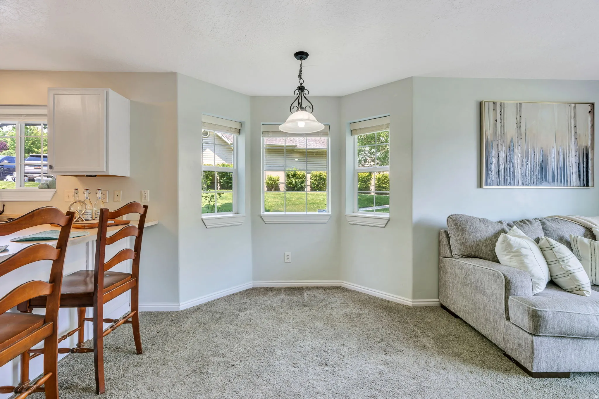 Bay window with three individual windows and a suspended ceiling light fixture
