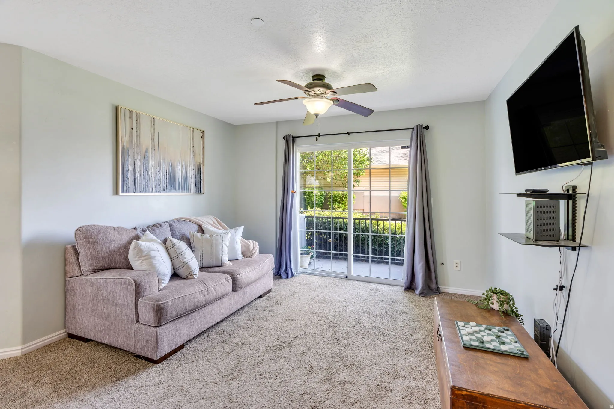 Living area featuring light gray walls and beige carpet