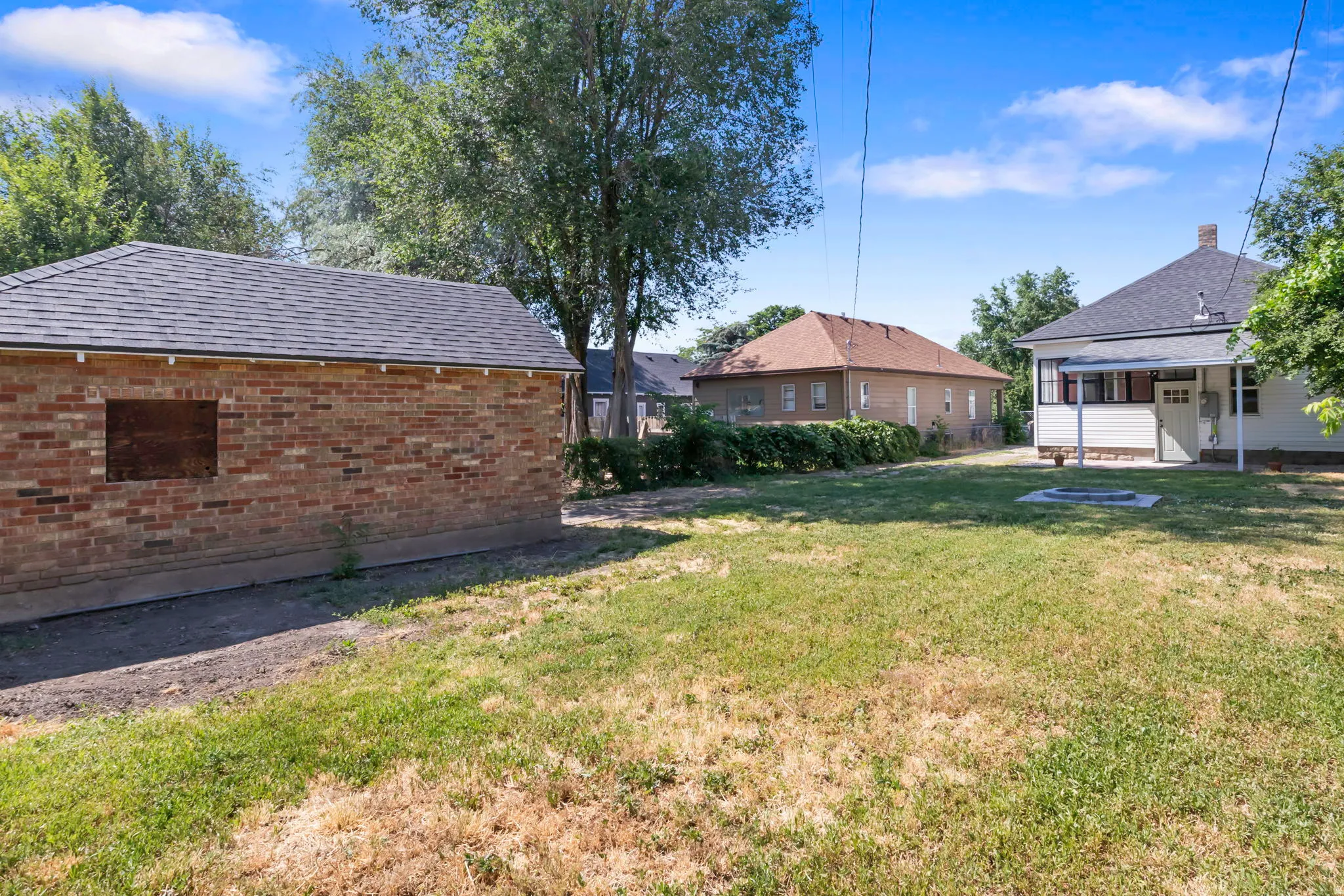 Brick outbuilding with shingled roof