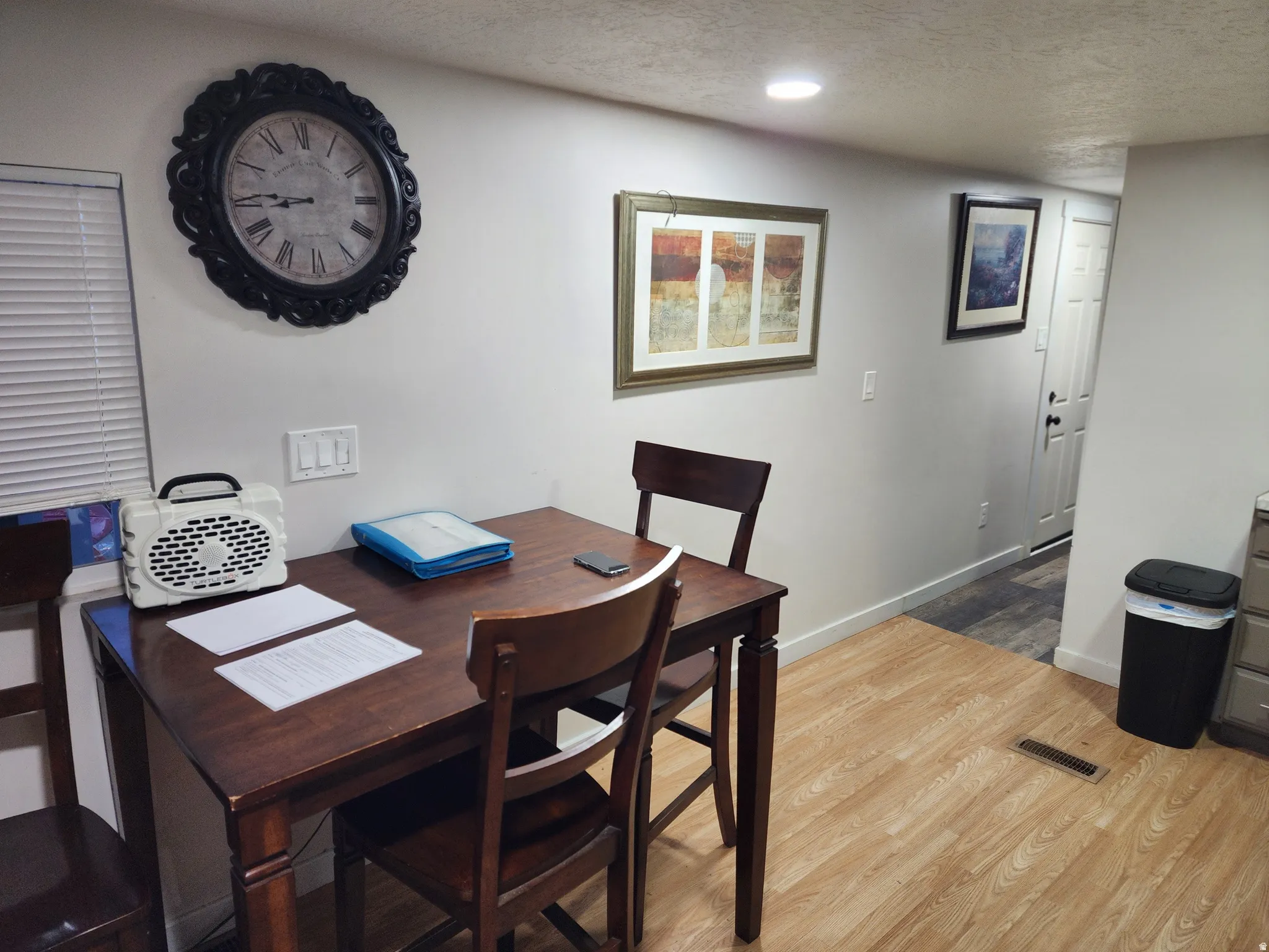 Room featuring wood-finish flooring, recessed lighting, and white baseboards
