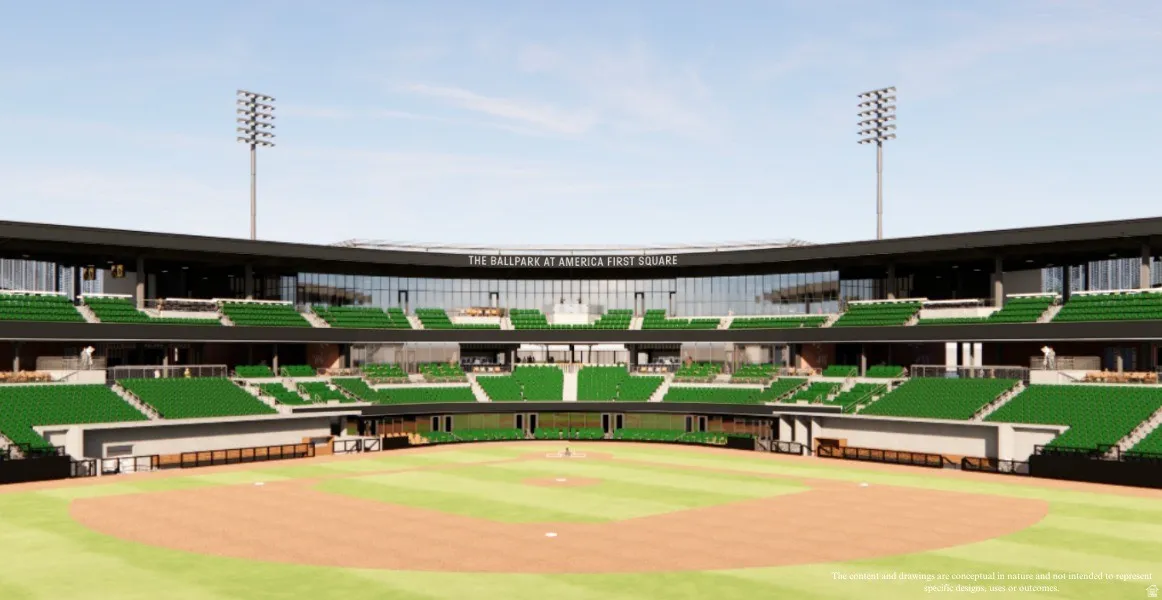 Baseball stadium featuring green seating, a large playing field with dirt and grass, a multi-level structure with extensive window lines, and prominent light towers