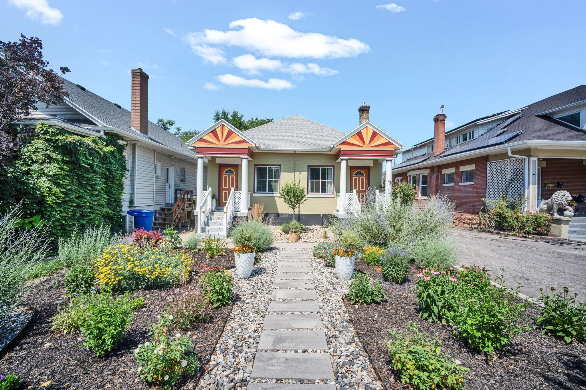 Symmetrical facade featuring dual entryways with decorative porch awnings
