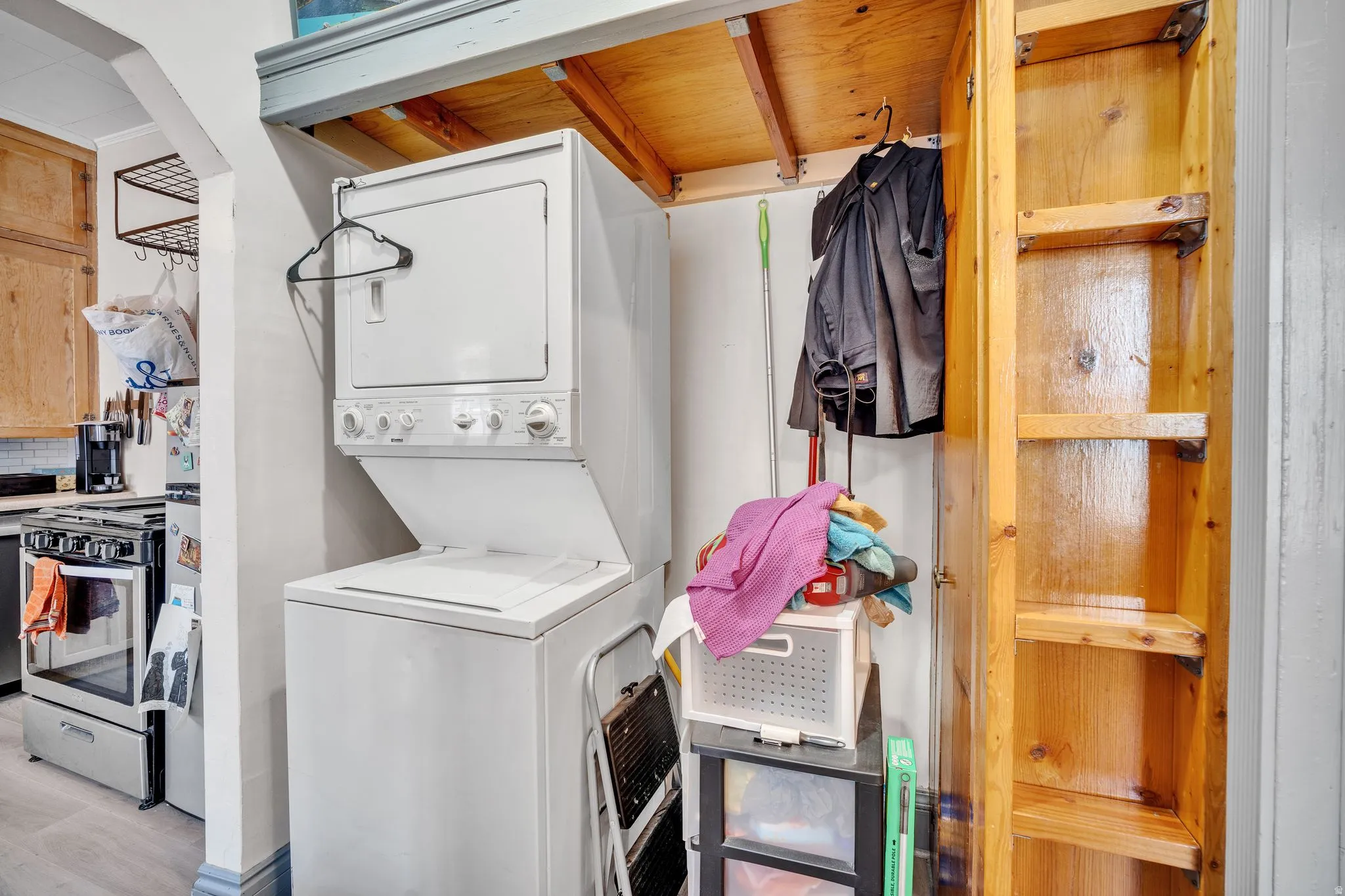 1 bedroom floorplan (618) laundry area featuring a stacked white washer and dryer unit