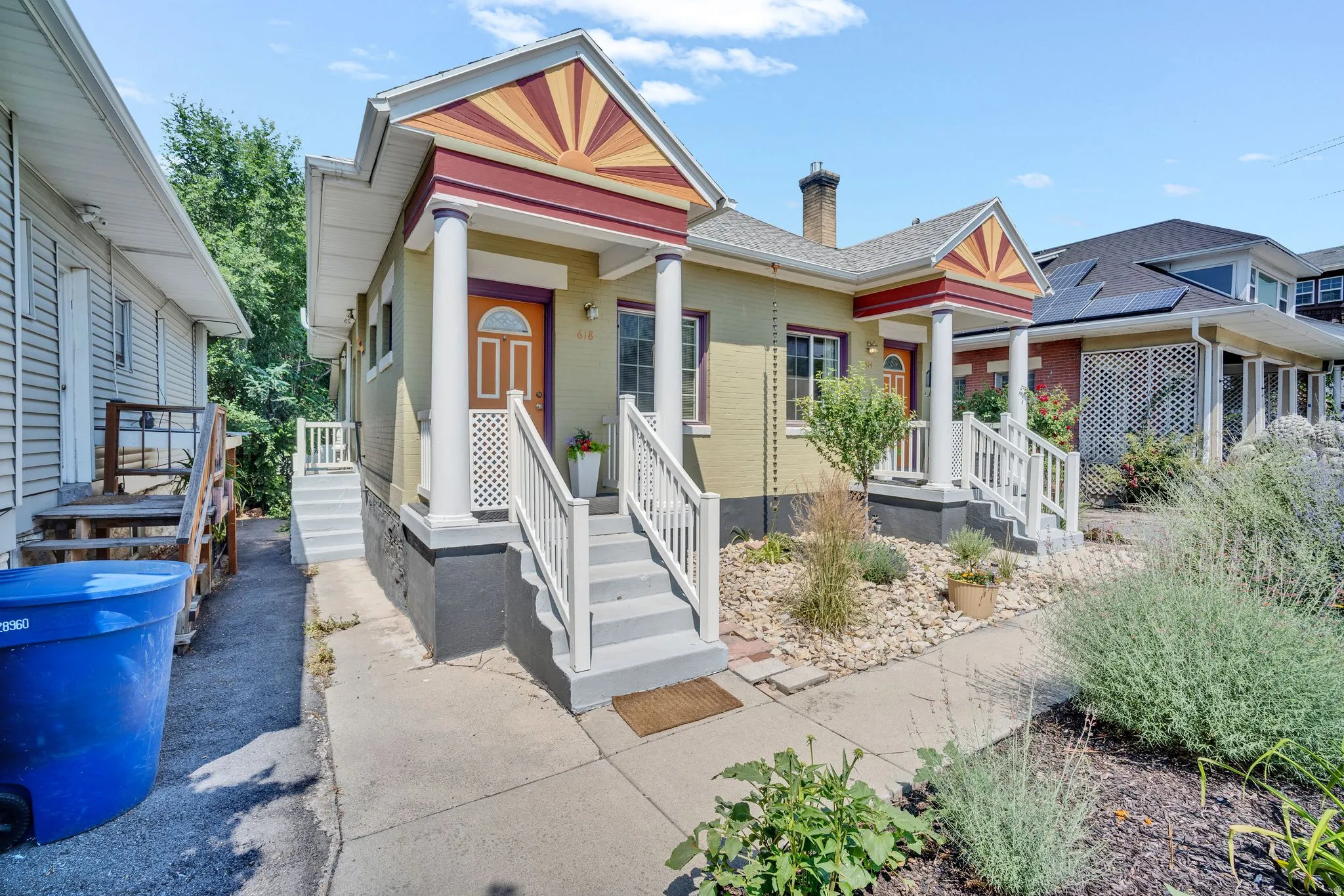 Exterior featuring multiple entryways with covered porches, decorative gables, and white column supports