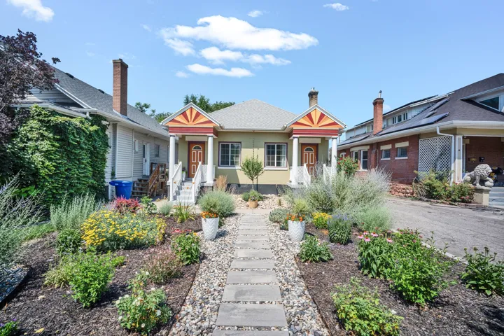 Symmetrical facade featuring dual entryways with decorative porch awnings
