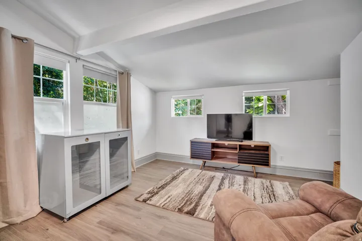 2-bedroom floorplan (614) bedroom #1 featuring wood-finish flooring, white painted walls, and multiple windows