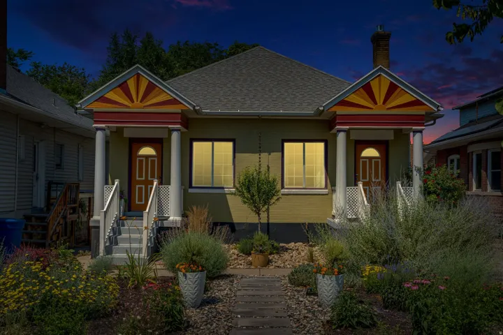 Symmetrical facade featuring two covered entryways with decorative columns