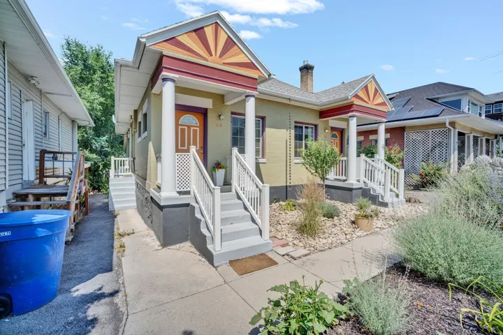 Exterior featuring multiple entryways with covered porches, decorative gables, and white column supports