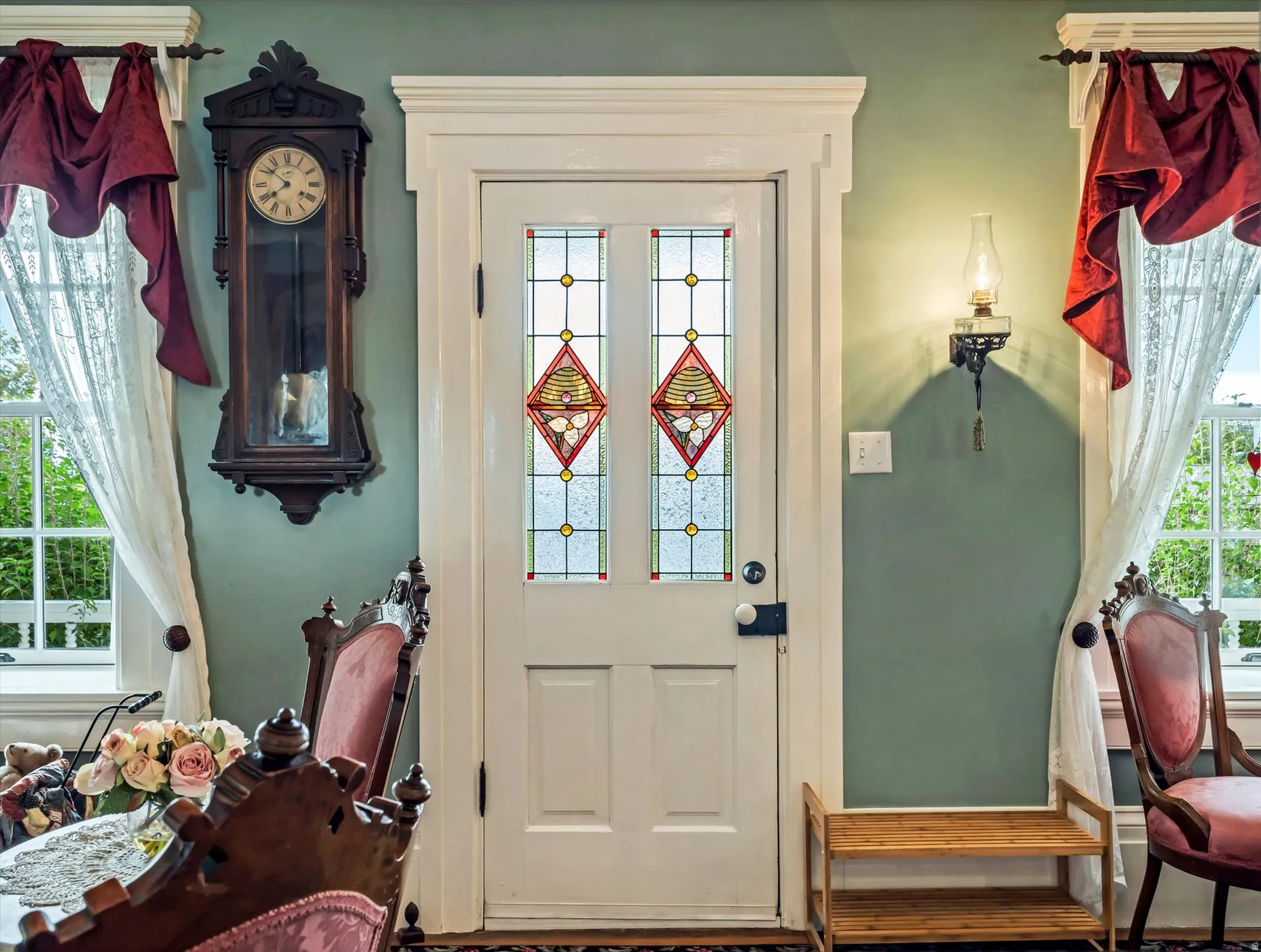 Entry door with decorative stained glass panels and white trim