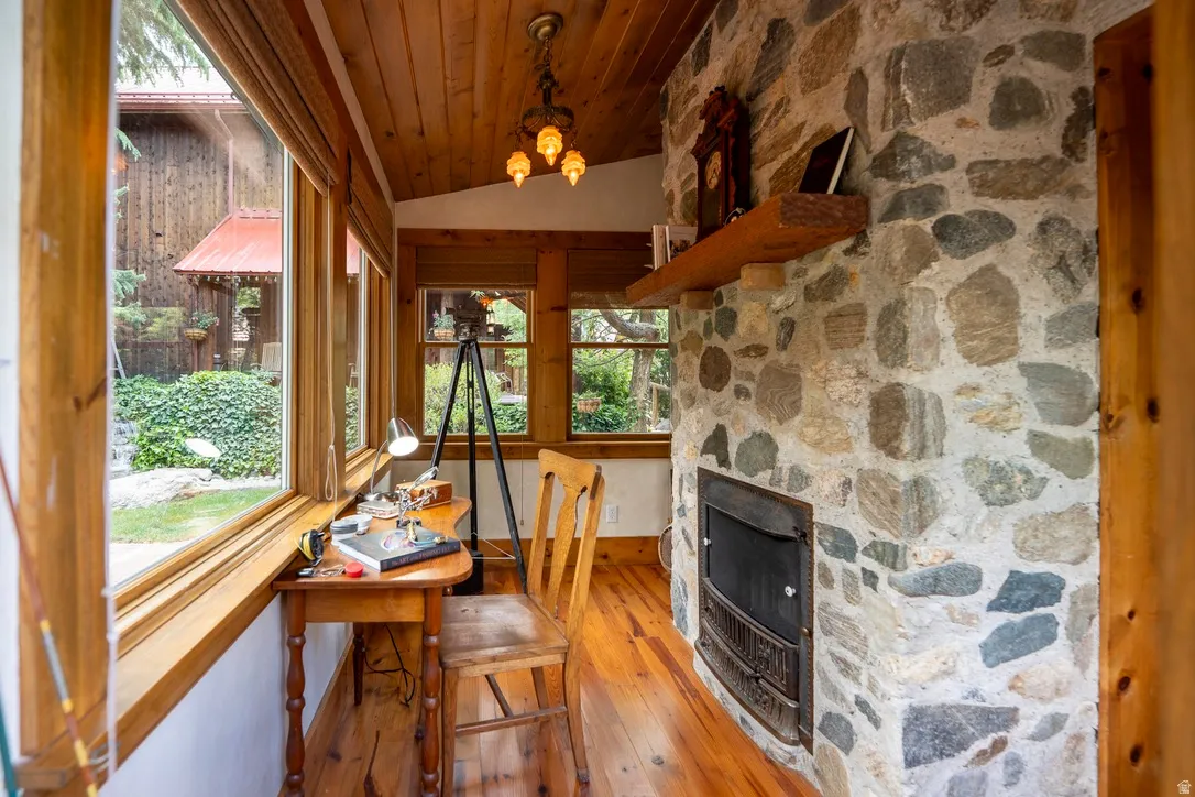Stone-faced fireplace with a wood mantel and metal insert