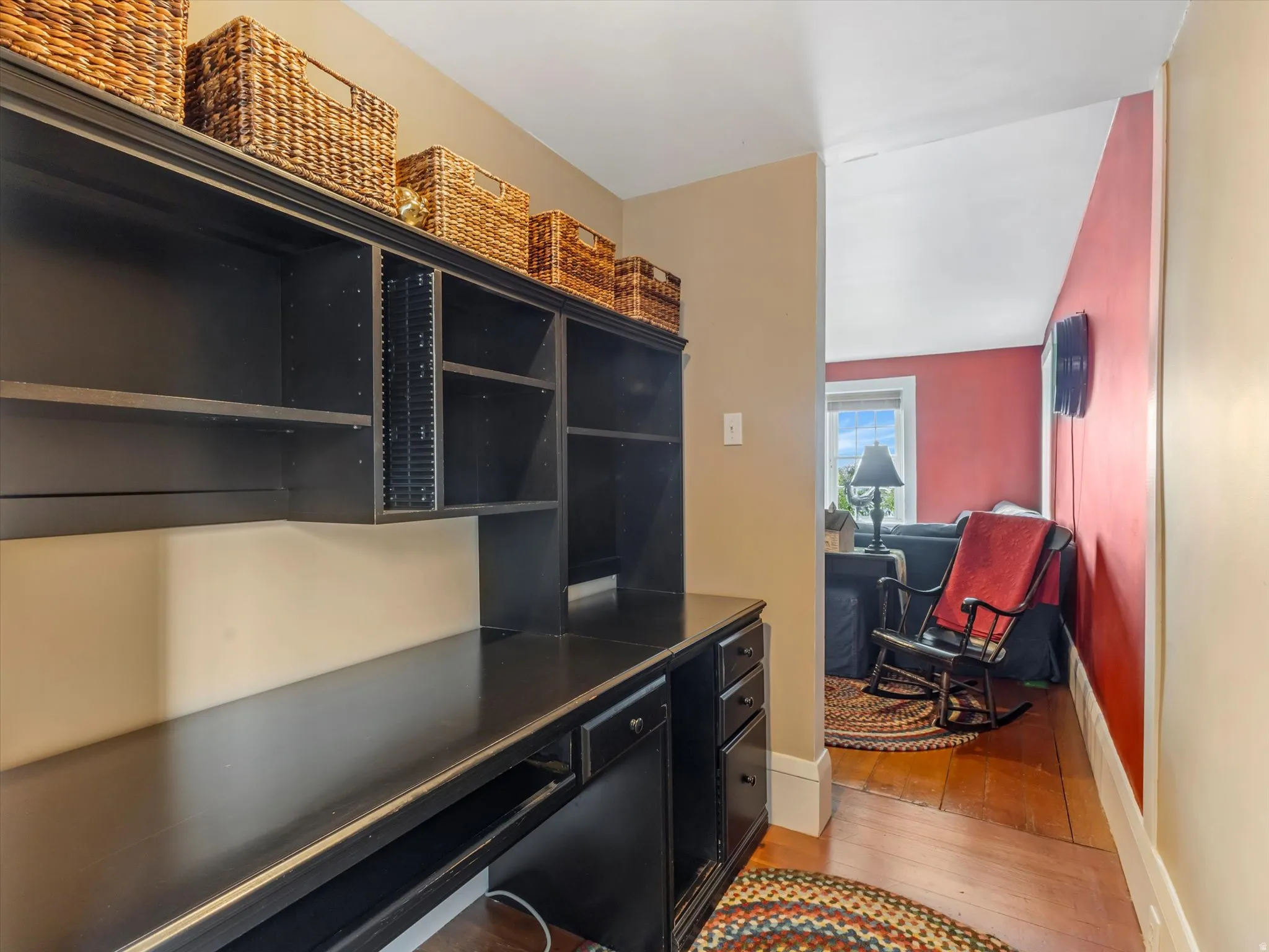 Built-in black cabinetry with integrated shelving and desk workspace