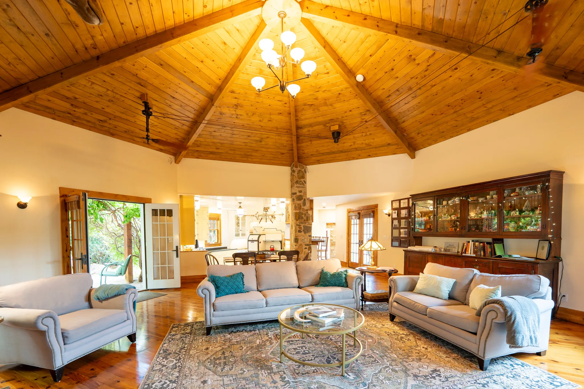 Vaulted wood-finish ceiling with exposed beams and recessed lighting