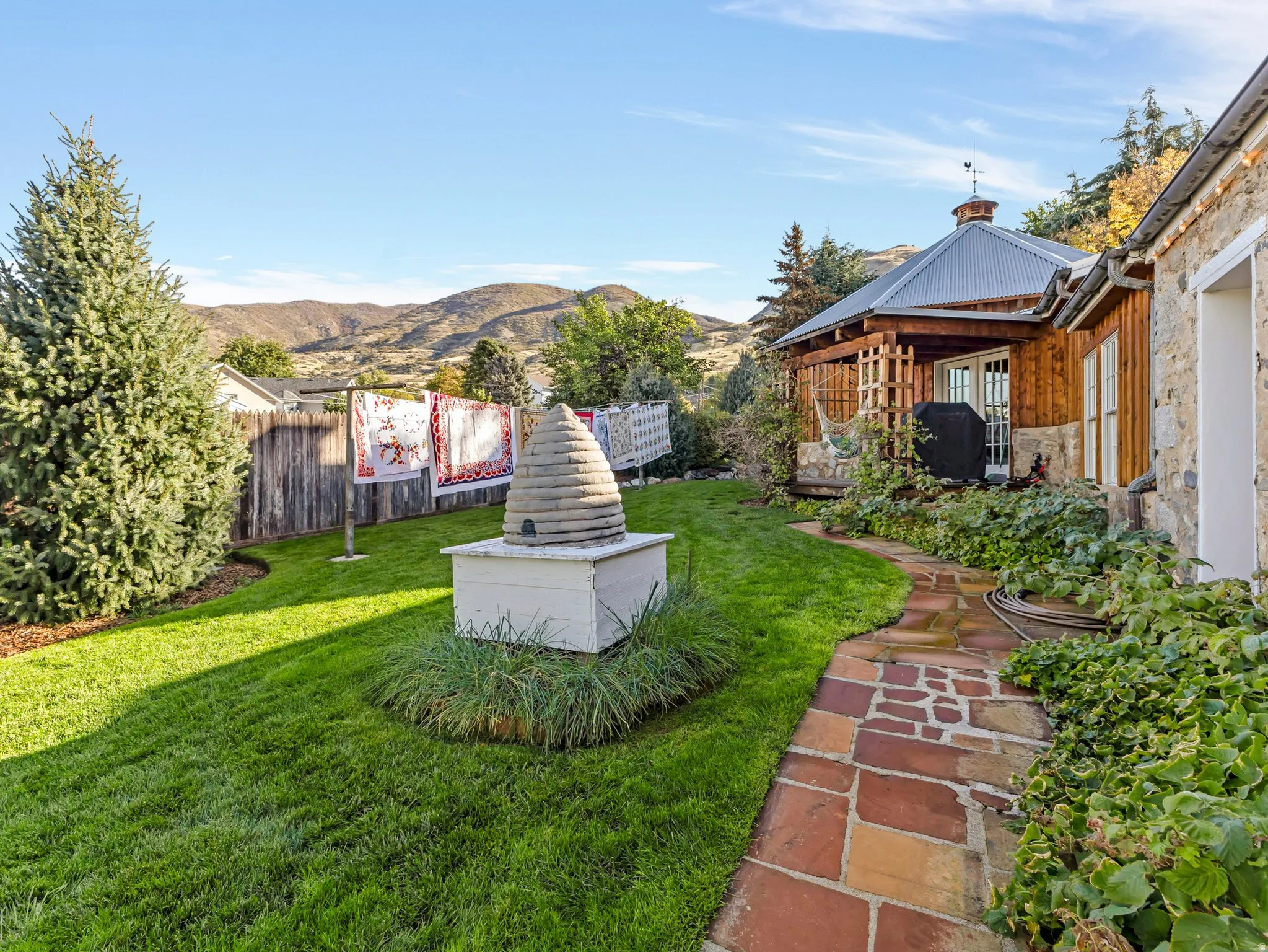 Manicured backyard with natural stone pathway