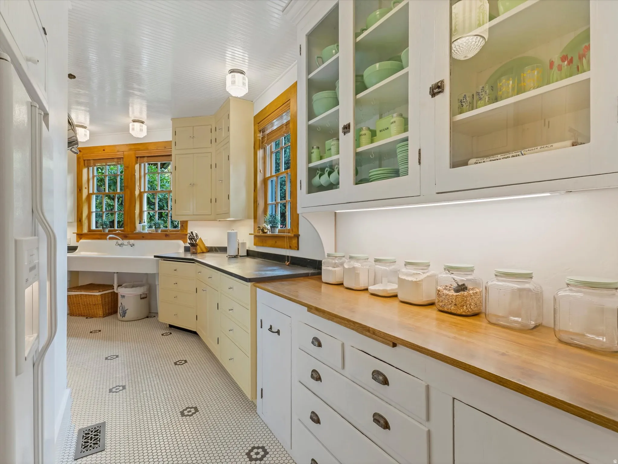 Kitchen featuring white beadboard ceiling, recessed lighting, white hex tile flooring with black accents, built-in cabinetry, and wood-finish countertops