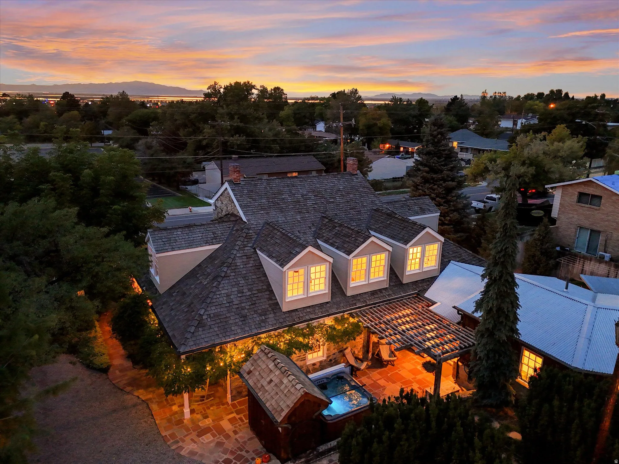 Multi-level shingle roofline featuring three dormer windows