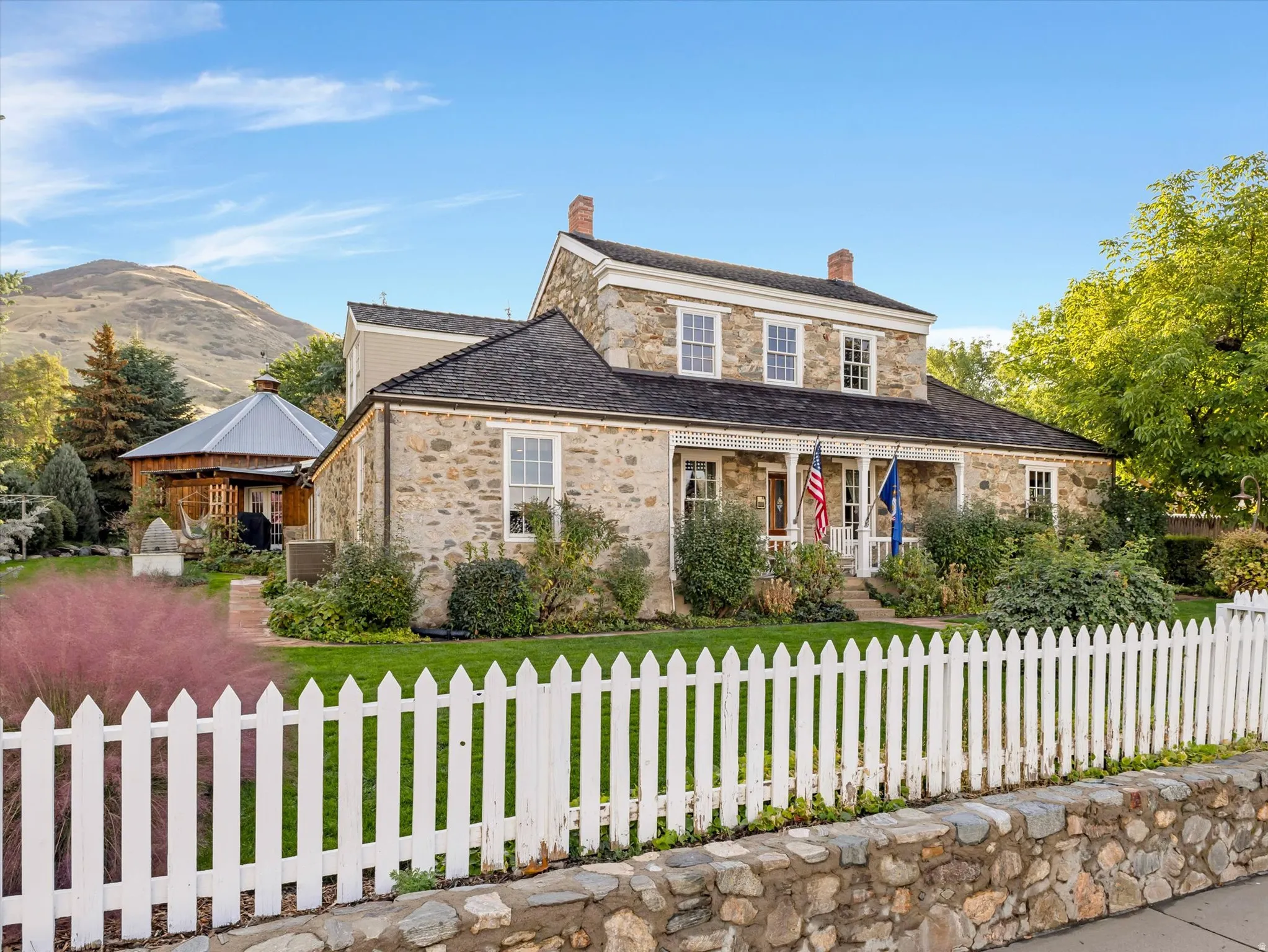Stone facade residence with a columned front porch.