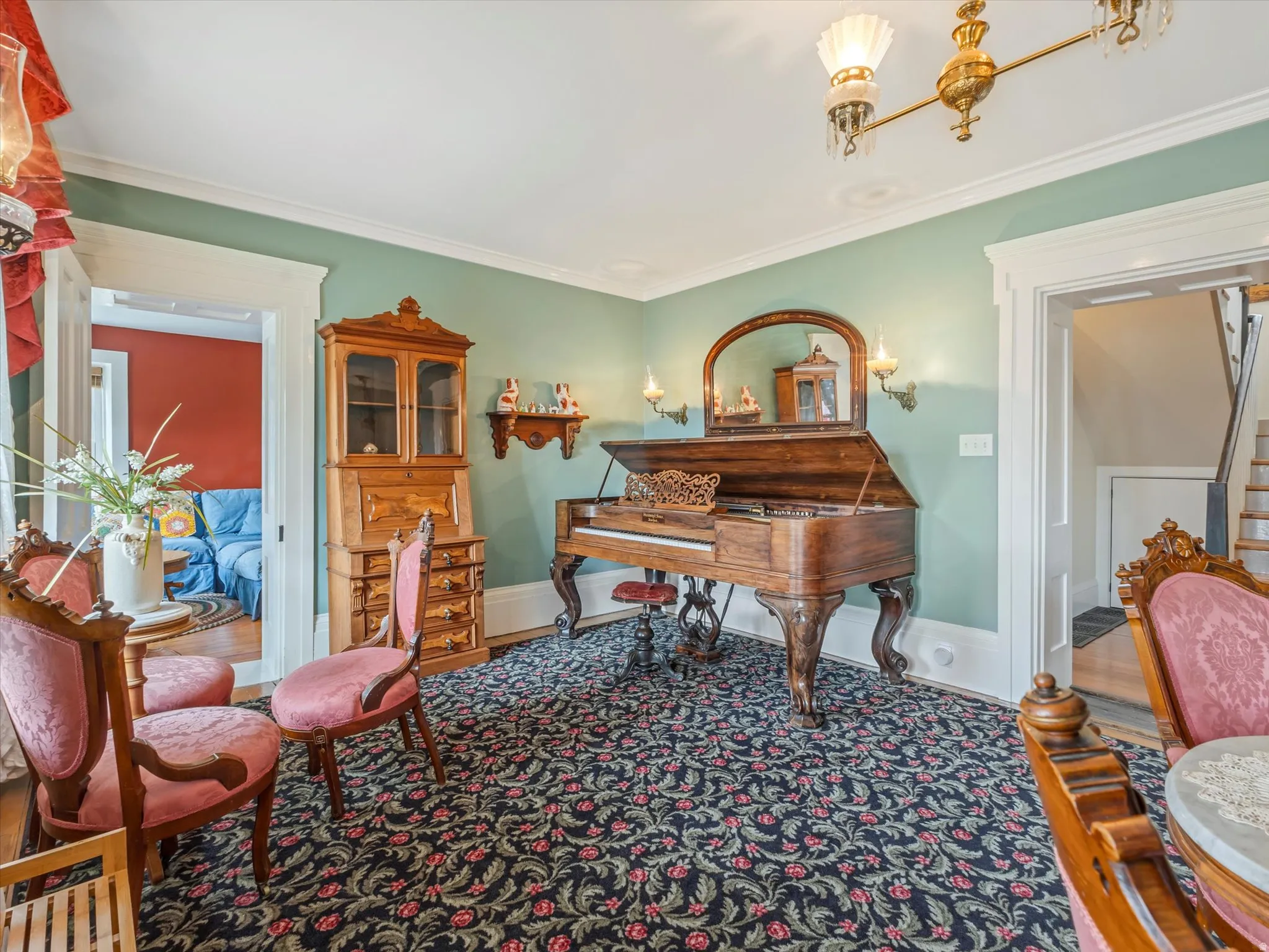 Interior room featuring a patterned area rug, light green wall paint, and white trim molding