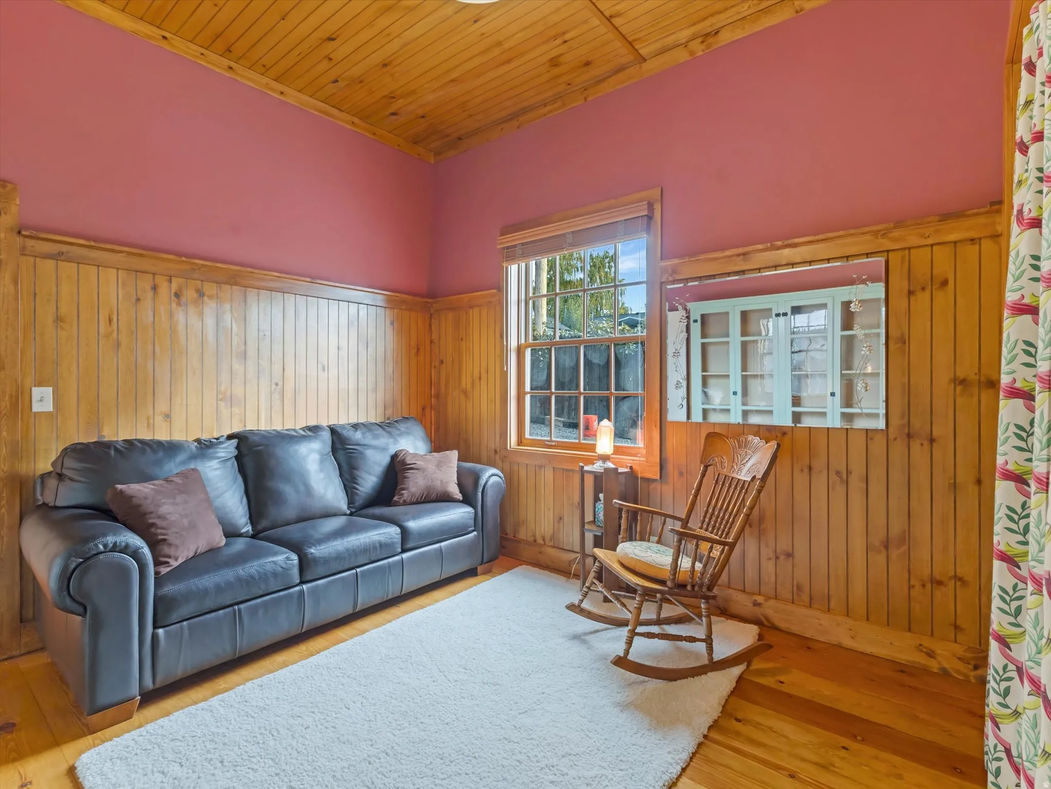 Guest Bedroom in ADU Wood-paneled walls and ceiling with a contrasting painted upper wall
