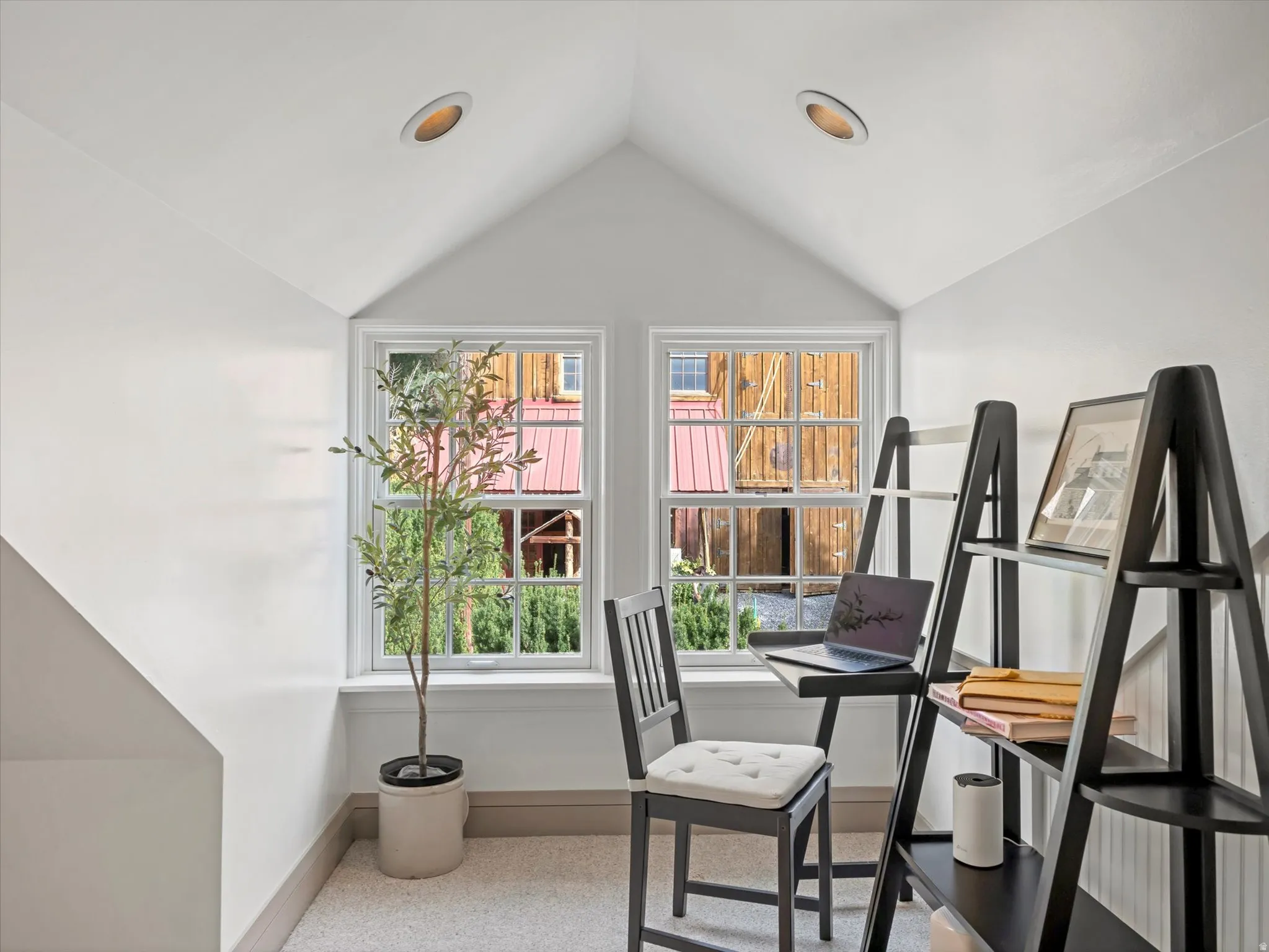 Attic space featuring a gabled ceiling, two double-hung windows, recessed lighting, and carpeted flooring