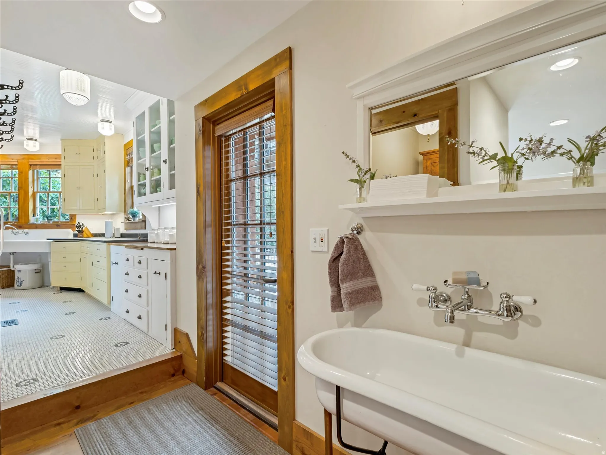 Vintage-style bathroom featuring a classic clawfoot tub with wall-mounted fixtures