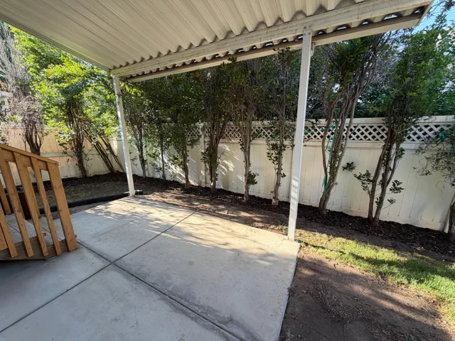 Covered patio with concrete slab flooring and metal overhead structure
