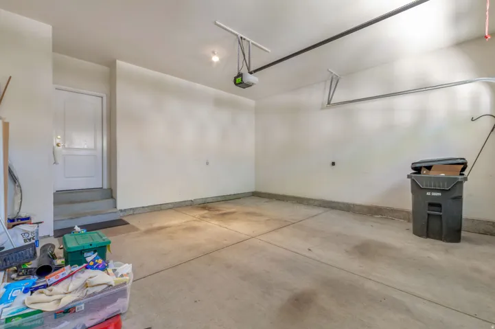 Spacious garage with concrete flooring, painted walls, and built-in overhead lighting