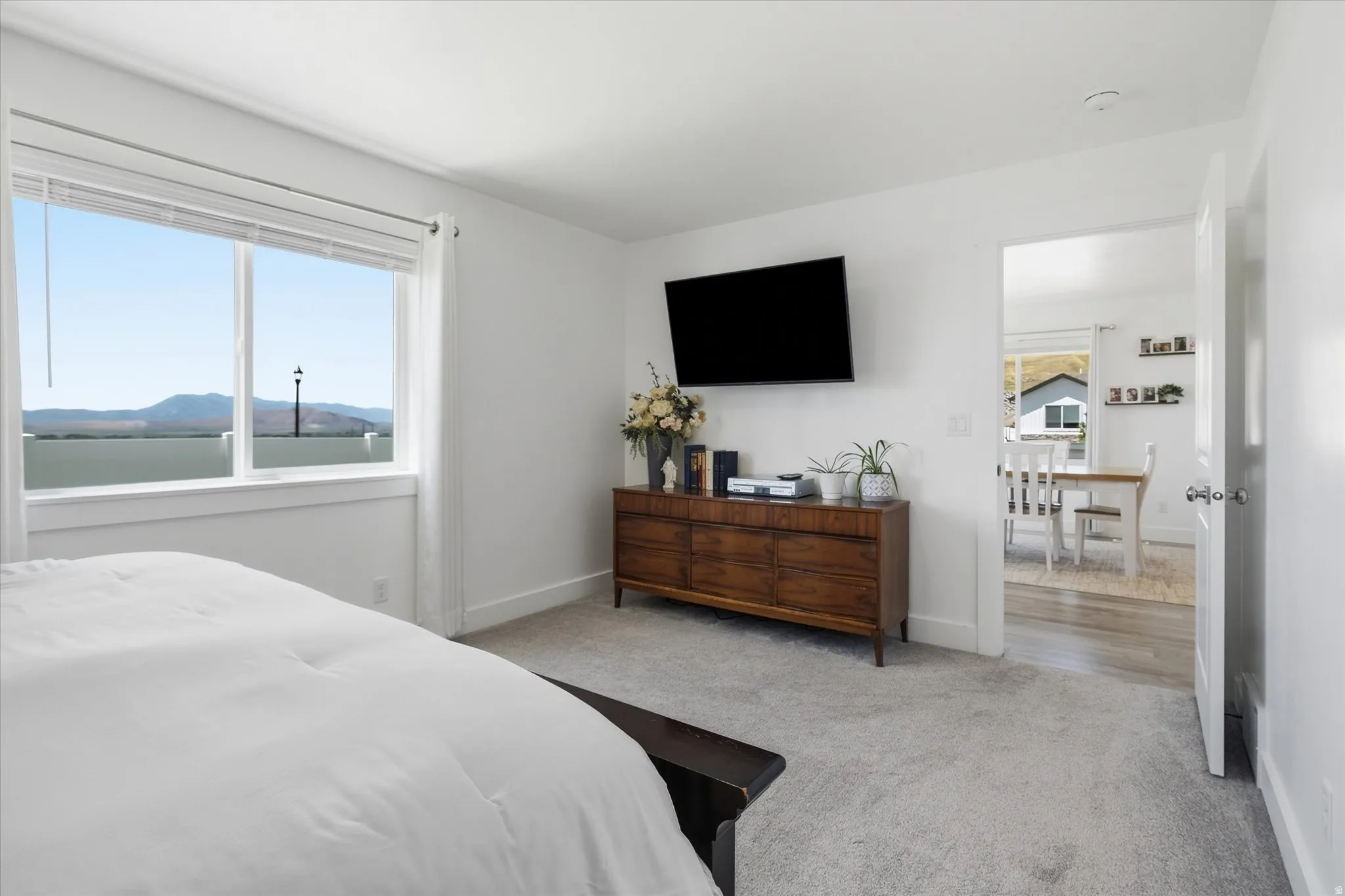 Bright room with a large window offering mountain scenery