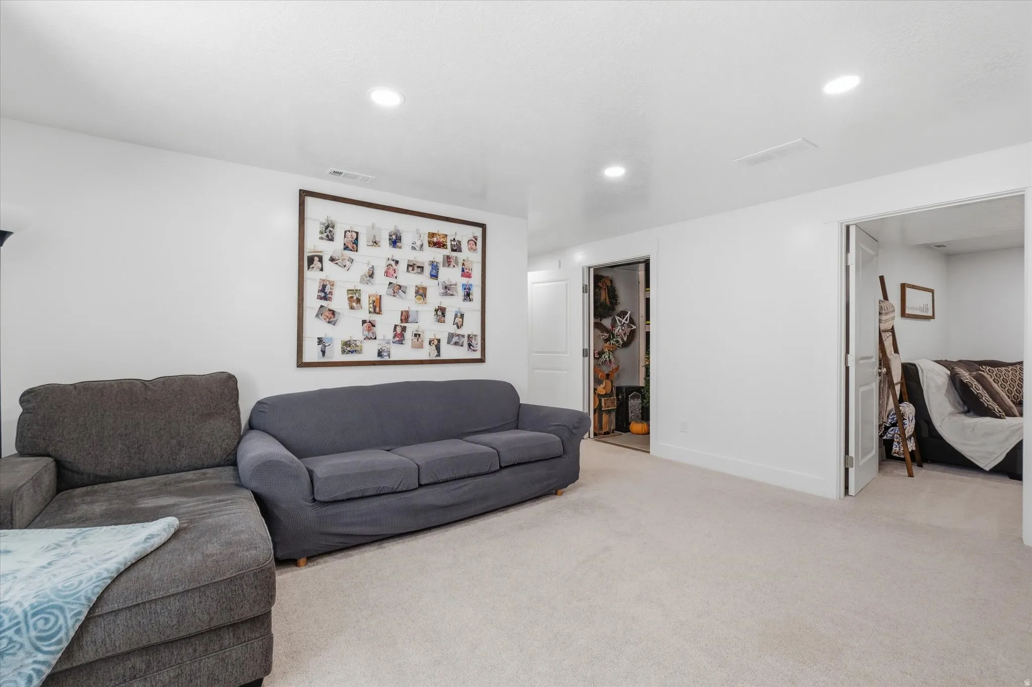 Carpeted room with recessed lighting and white walls