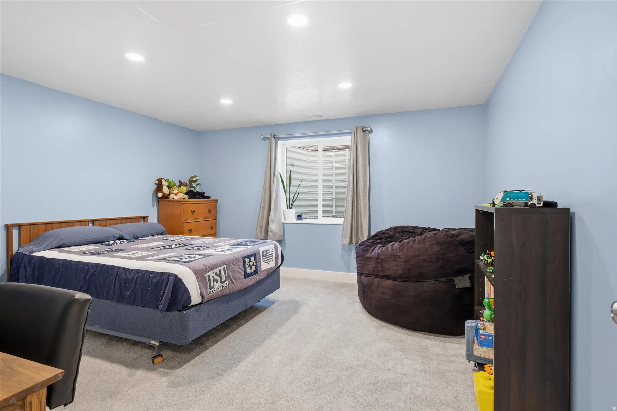 Light blue walls complementing light-toned carpeting and white baseboards