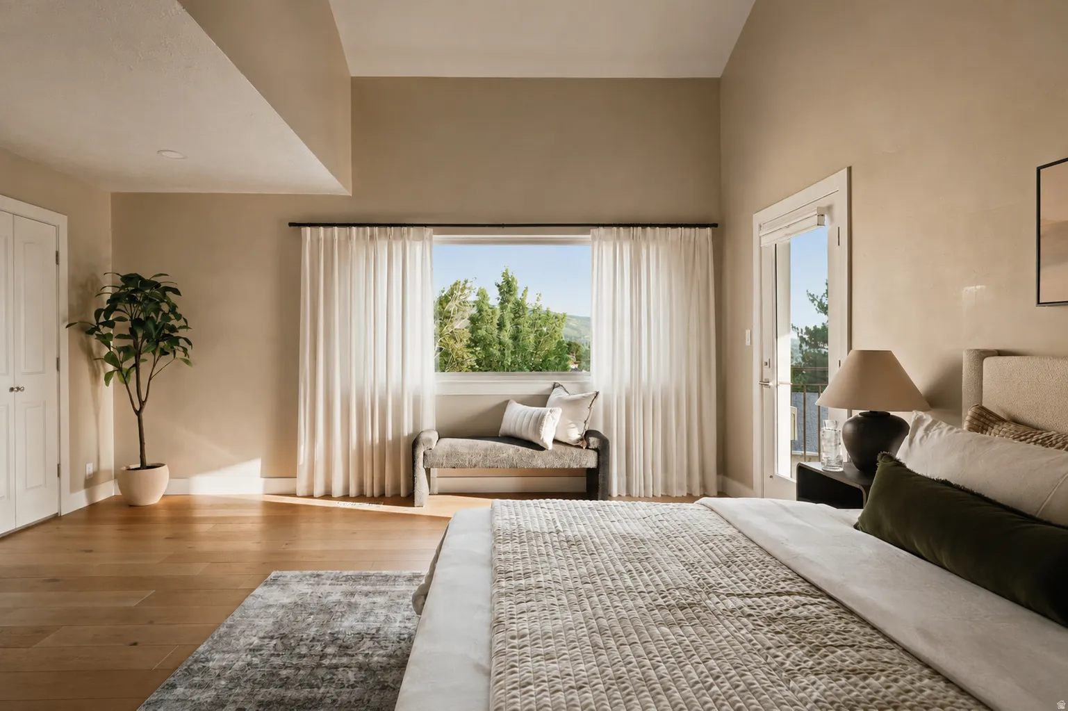 Spacious room with light wood-finish flooring and a neutral color palette