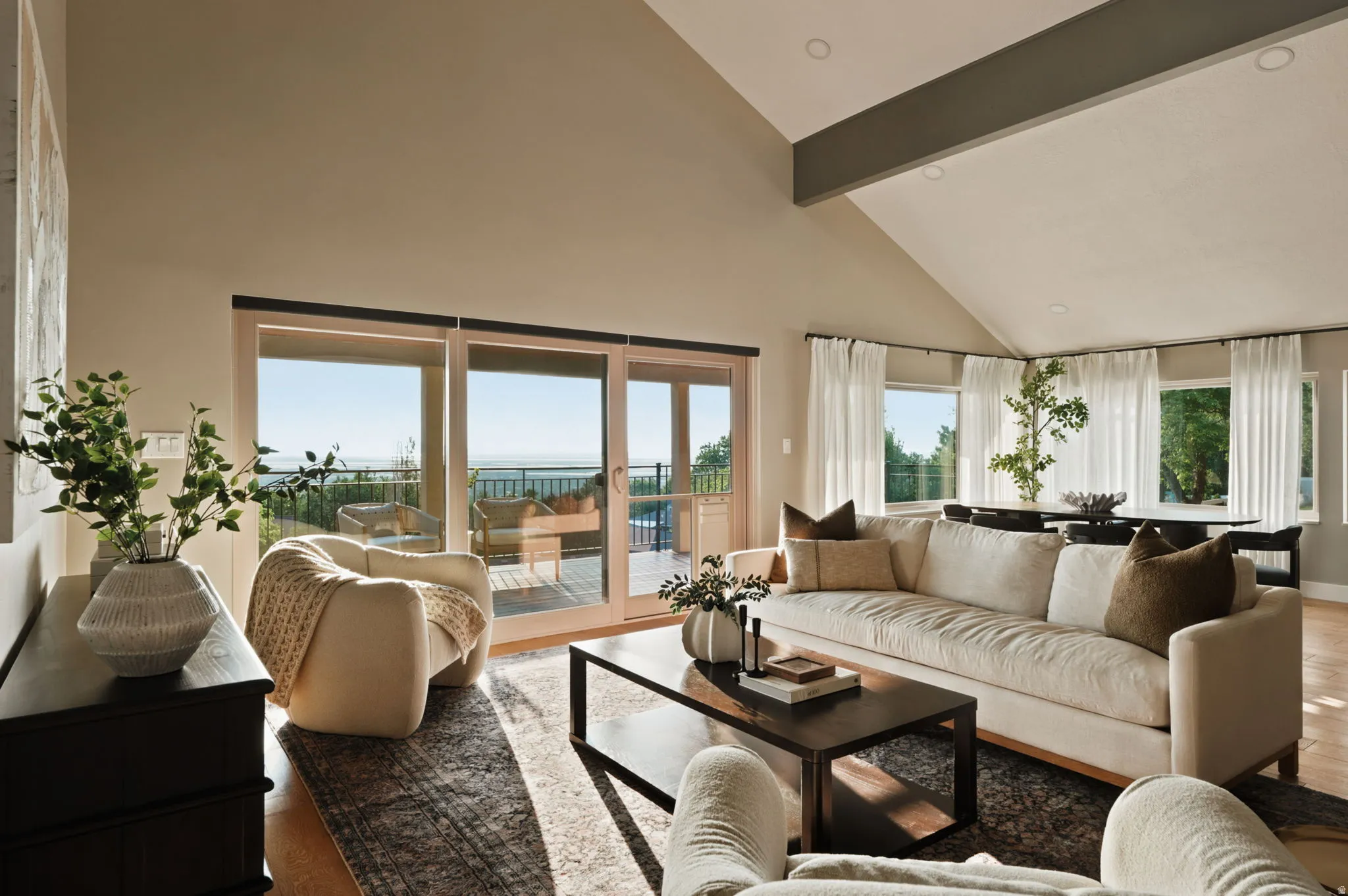 Living area with vaulted ceilings and exposed beam