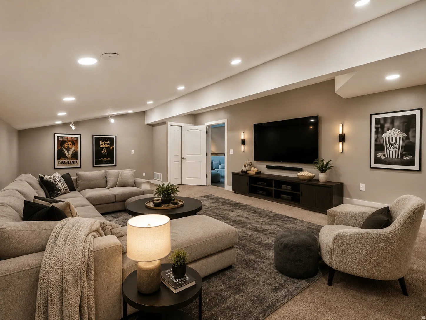 Spacious recreation room featuring recessed lighting, a built-in media console, and dual wall sconces