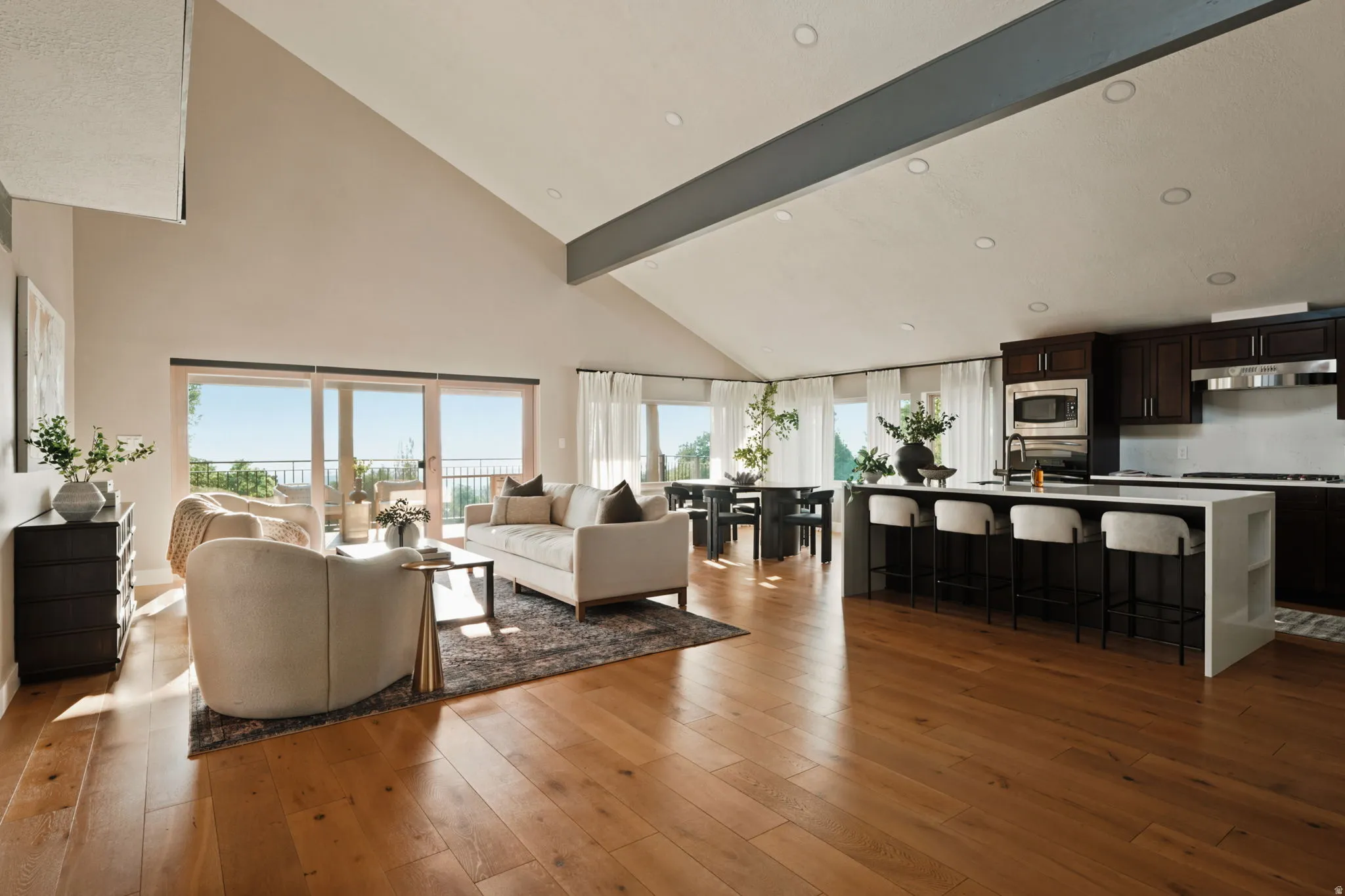 Open-concept living area with vaulted ceilings and wood-finish flooring