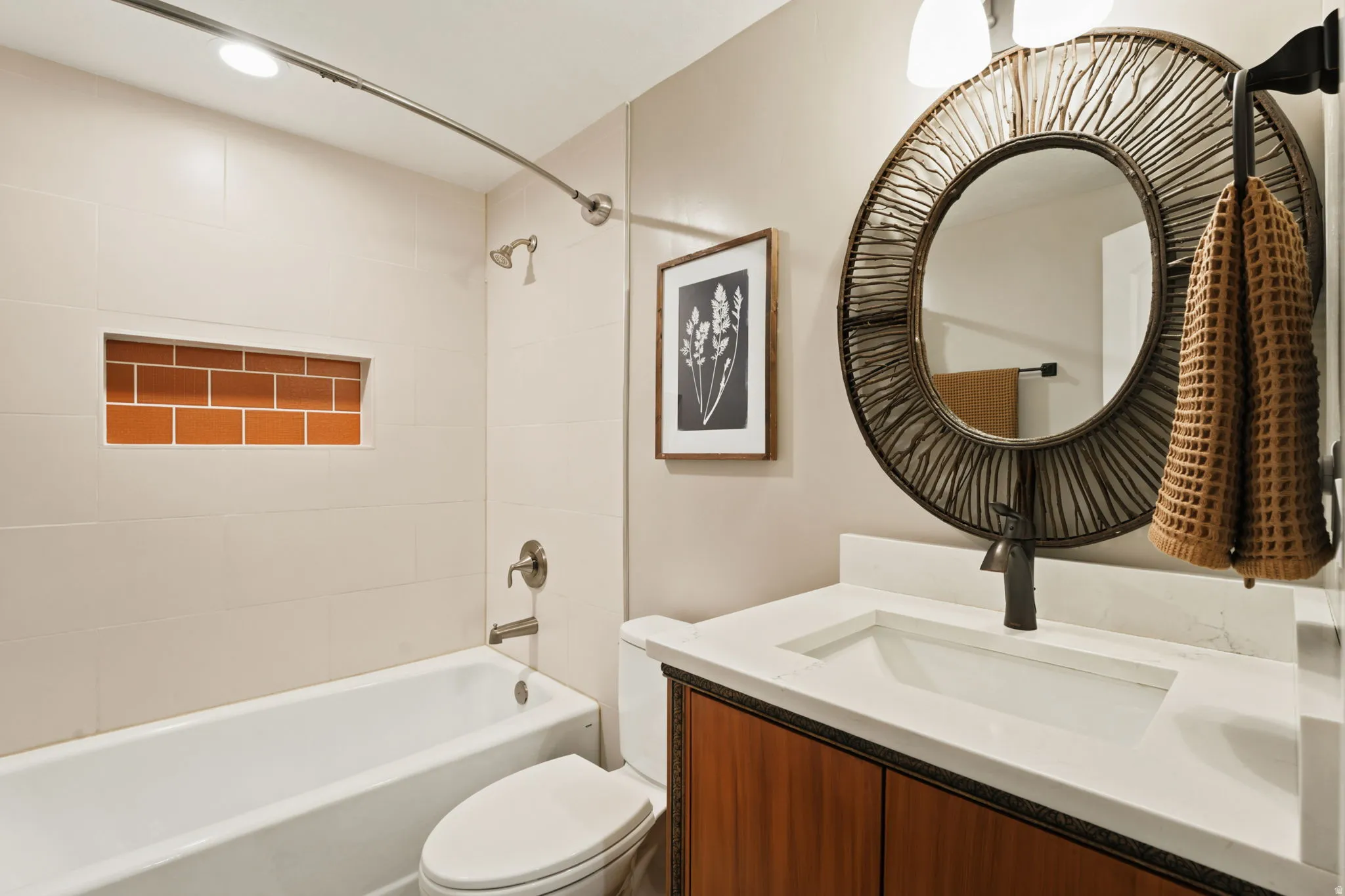 Bathroom featuring a wood-finish vanity with a white countertop and integrated sink
