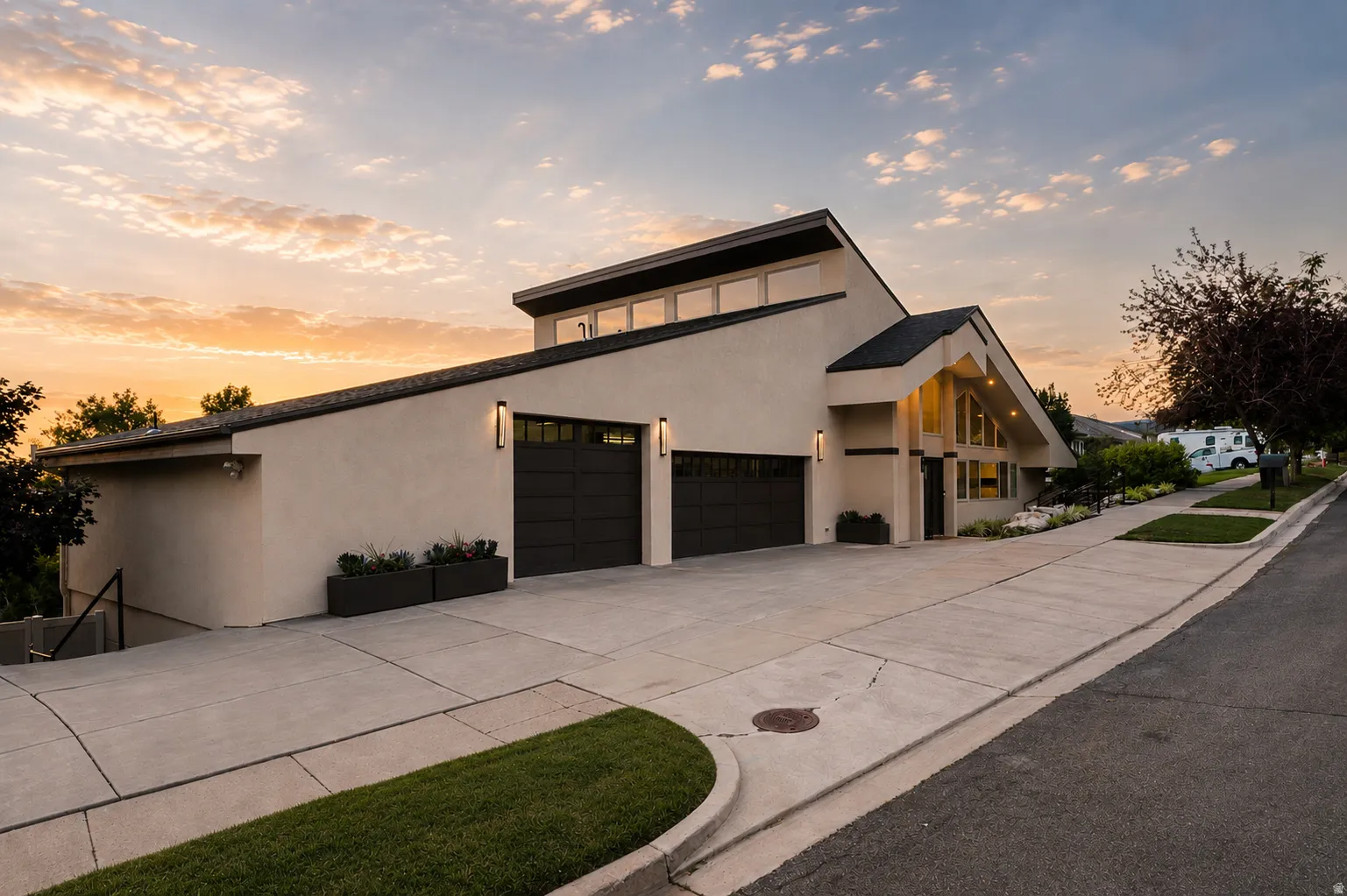 Modern stucco exterior with a distinctive angled roofline and a prominent two-car garage