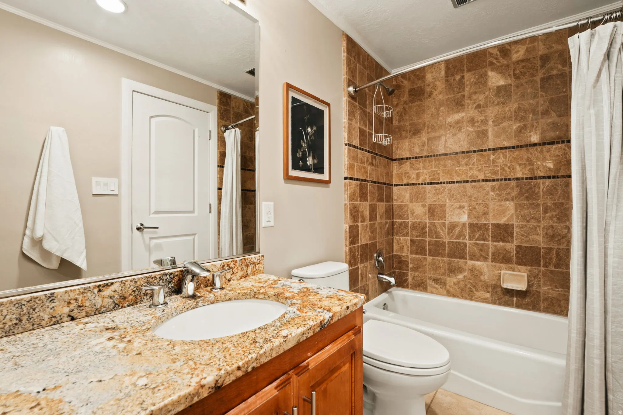 Bathroom featuring a vanity with an undermount sink and granite countertop, complete with a chrome faucet