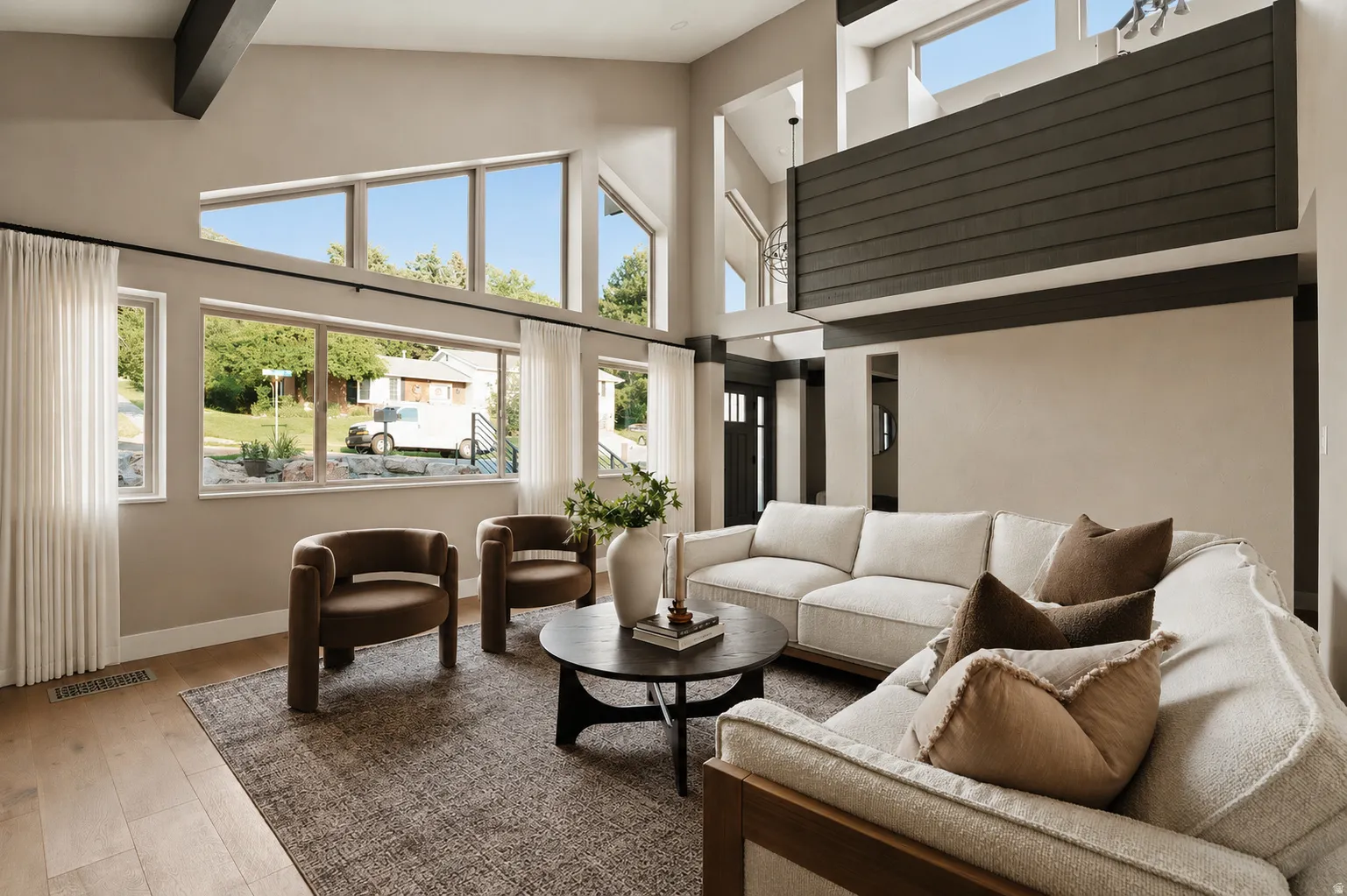 Two-story living area with soaring ceilings and exposed structural beams