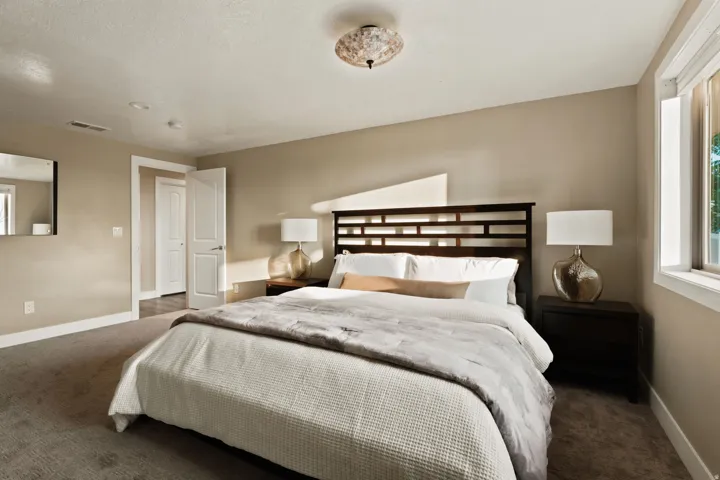 Spacious room featuring neutral-toned walls, recessed lighting, and a large window providing natural illumination